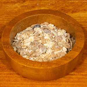Muesli deluxe 100g bowl with oats, nuts, seeds, and dried fruits.