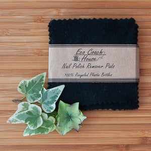 Eco Coach House nail polish remover pads with leaves on a wooden surface.