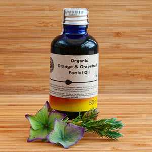 Organic Orange and Grapefruit Facial Oil by Heavenly Organics on a wooden background.