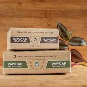 Stainless Steel Reusable Coffee Capsules by Waycap on a wooden surface.