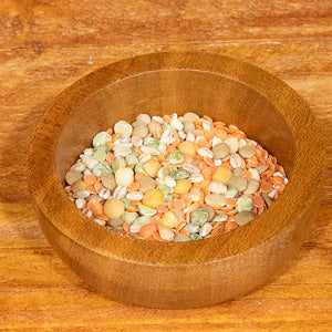 Soup mix 100g in a wooden bowl on a wooden surface.