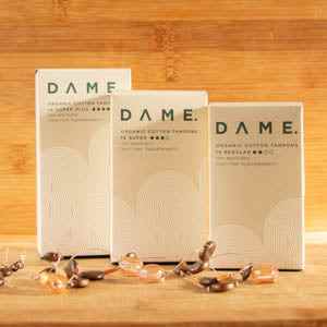 Tampons by Dame packaging showcasing eco-friendly and sustainable feminine care products on a wooden surface.