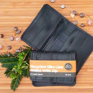 Slim line wallet with zip by Cycle of Good on display with eco-friendly design.