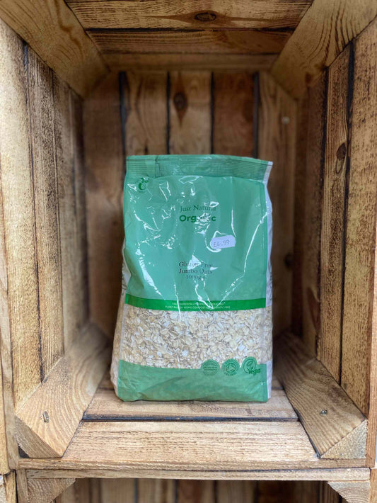 Organic GF Jumbo Oats in eco-friendly packaging displayed on wooden shelves.