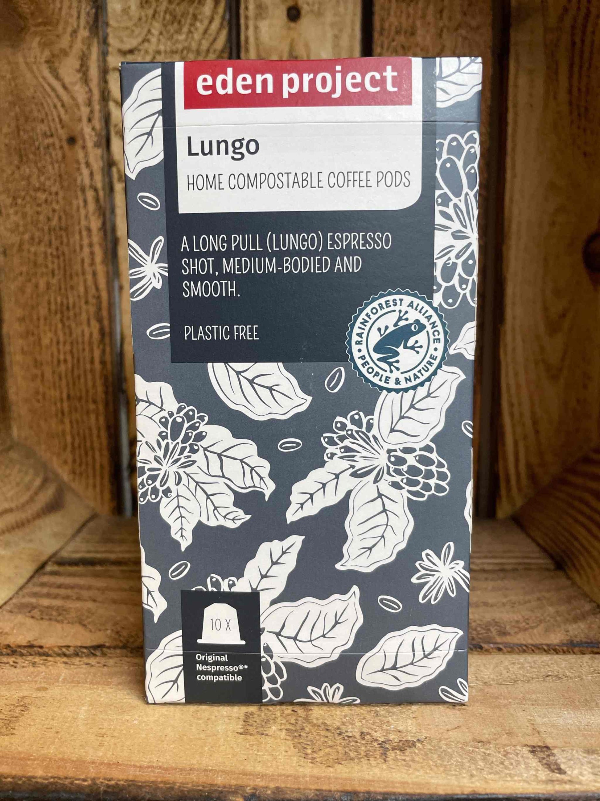 Eden Project Lungo Coffee Capsules box on wooden background, featuring sustainable and eco-friendly packaging.