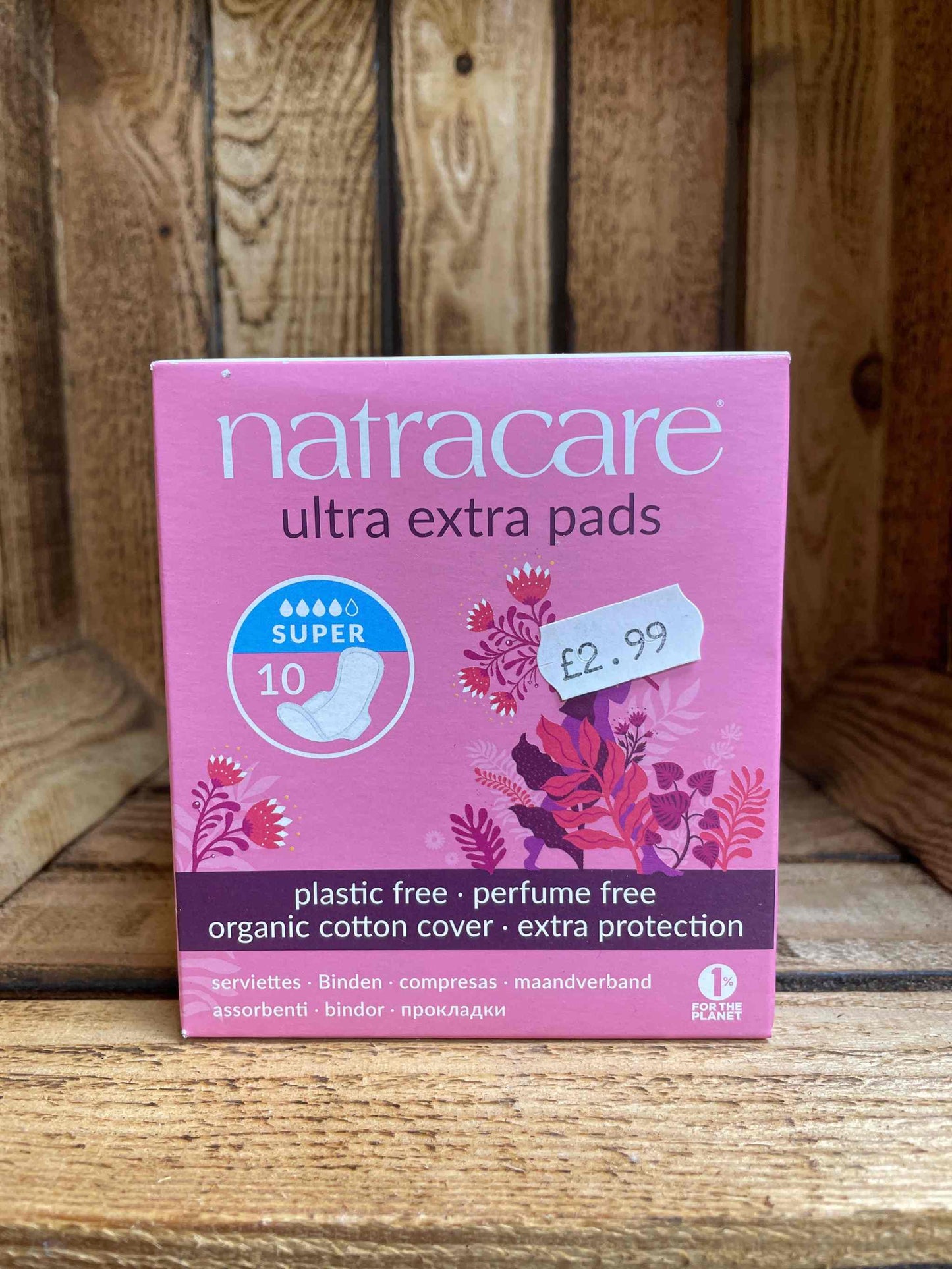 Natracare Pads box on wooden shelf, eco-friendly, ultra absorbent, plastic-free, organic cotton.