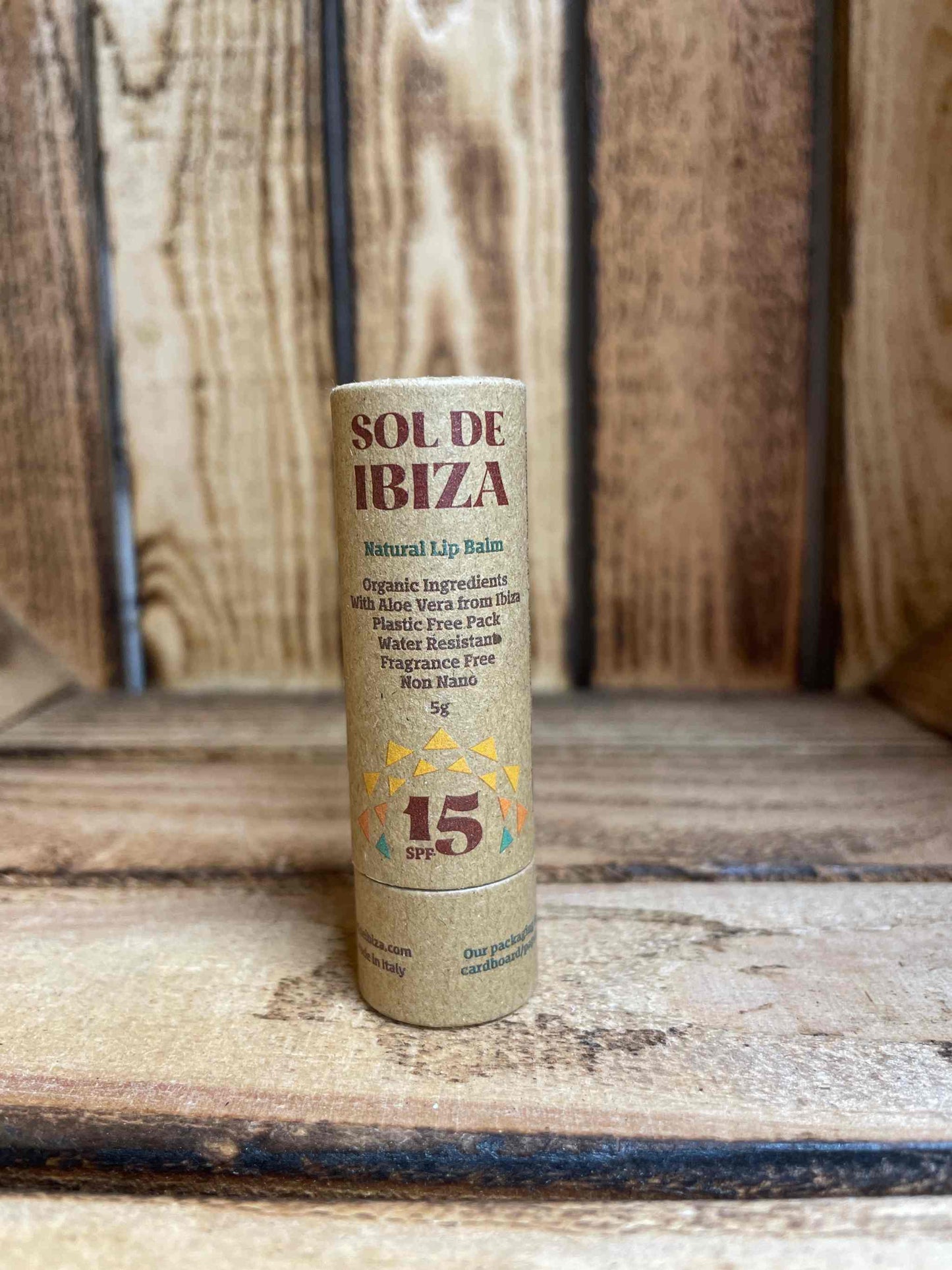 Sol de Ibiza lip balm in eco-friendly packaging on wooden background.