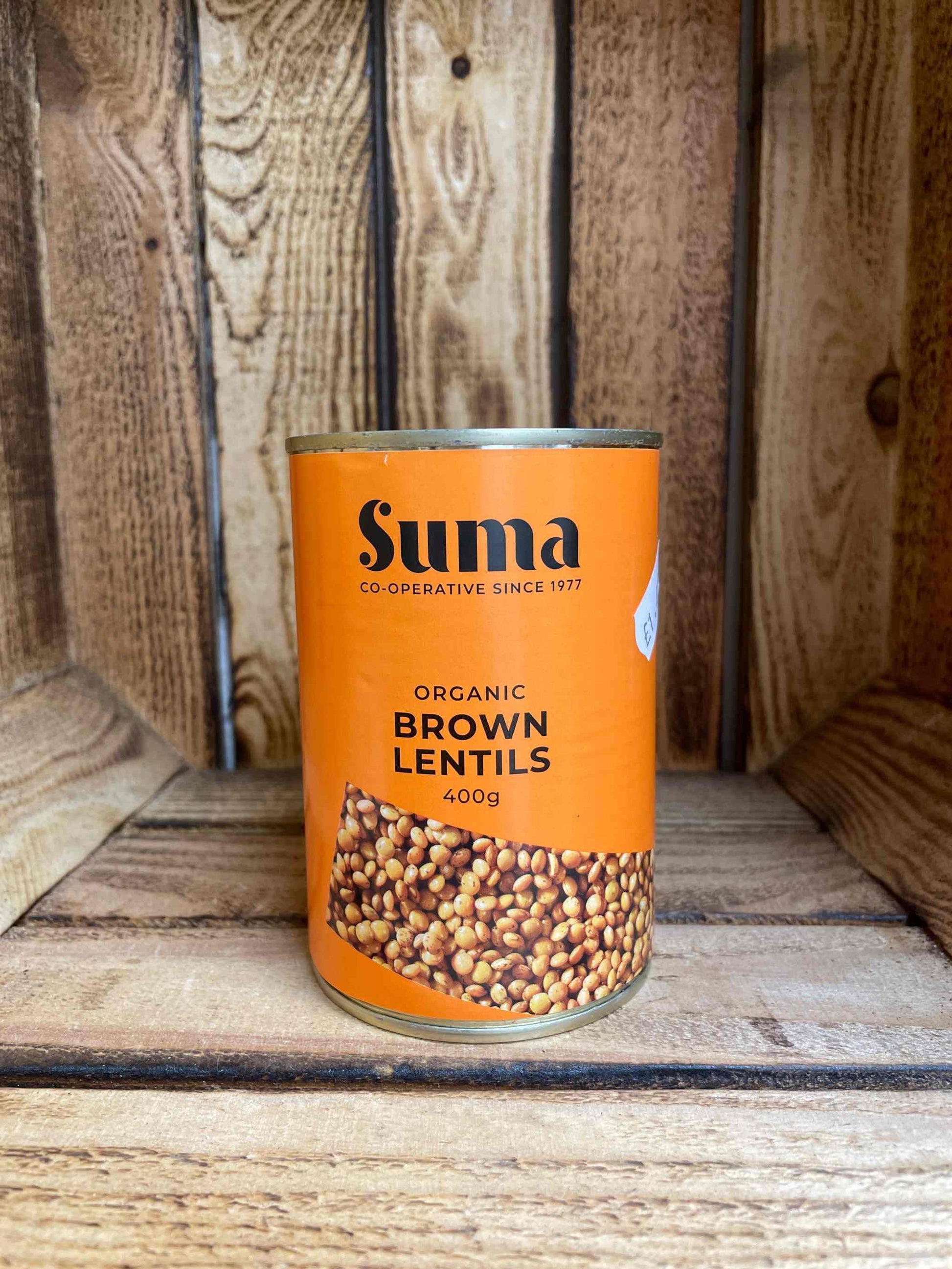 Suma Organic Brown Lentils 400g can on wooden surface