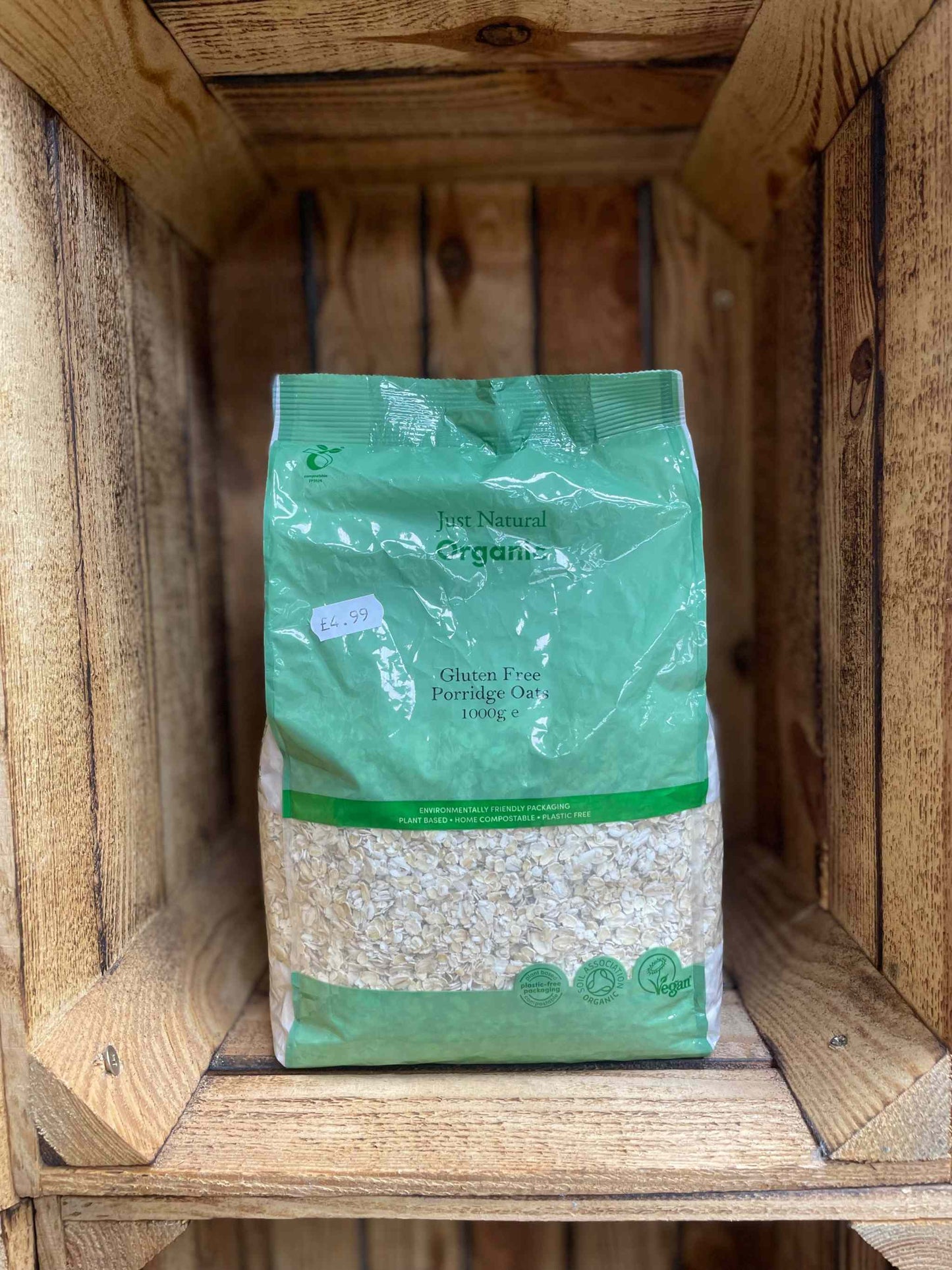 Organic Gluten Free Porridge Oats, 500g package in a wooden crate.