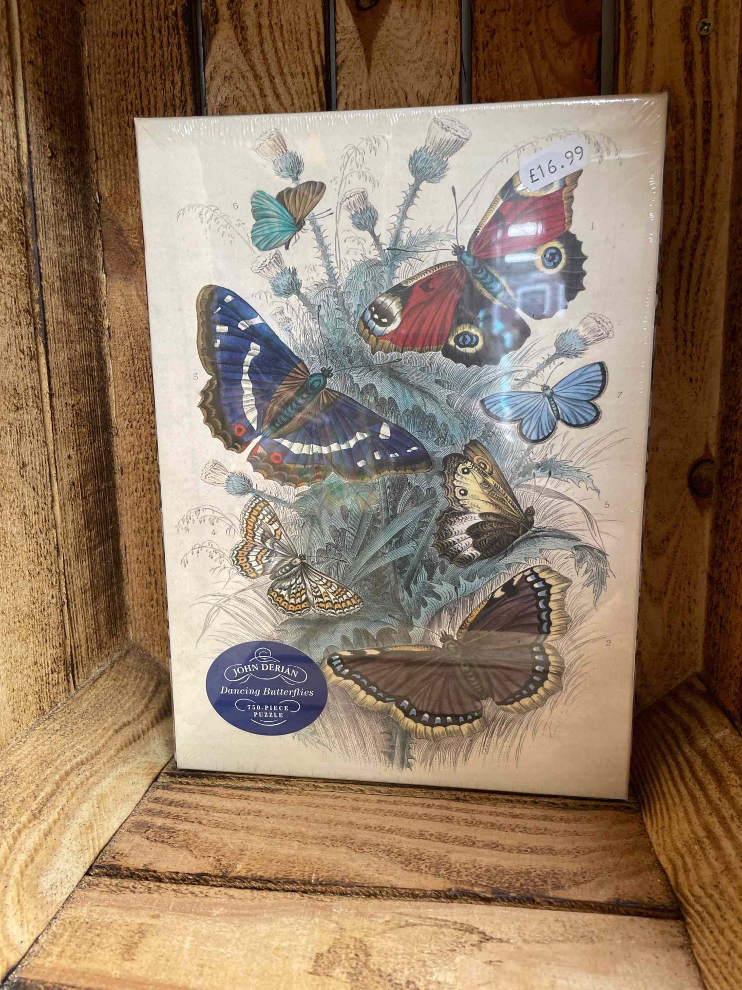 Dancing butterflies puzzle with vibrant butterfly illustrations displayed in a wooden setting.