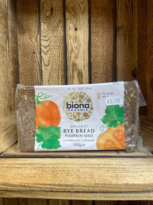 Organic rye bread with pumpkin seed on wooden shelf packaging.