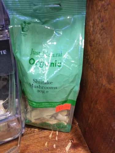 Organic shiitake mushrooms 30g package on display shelf.