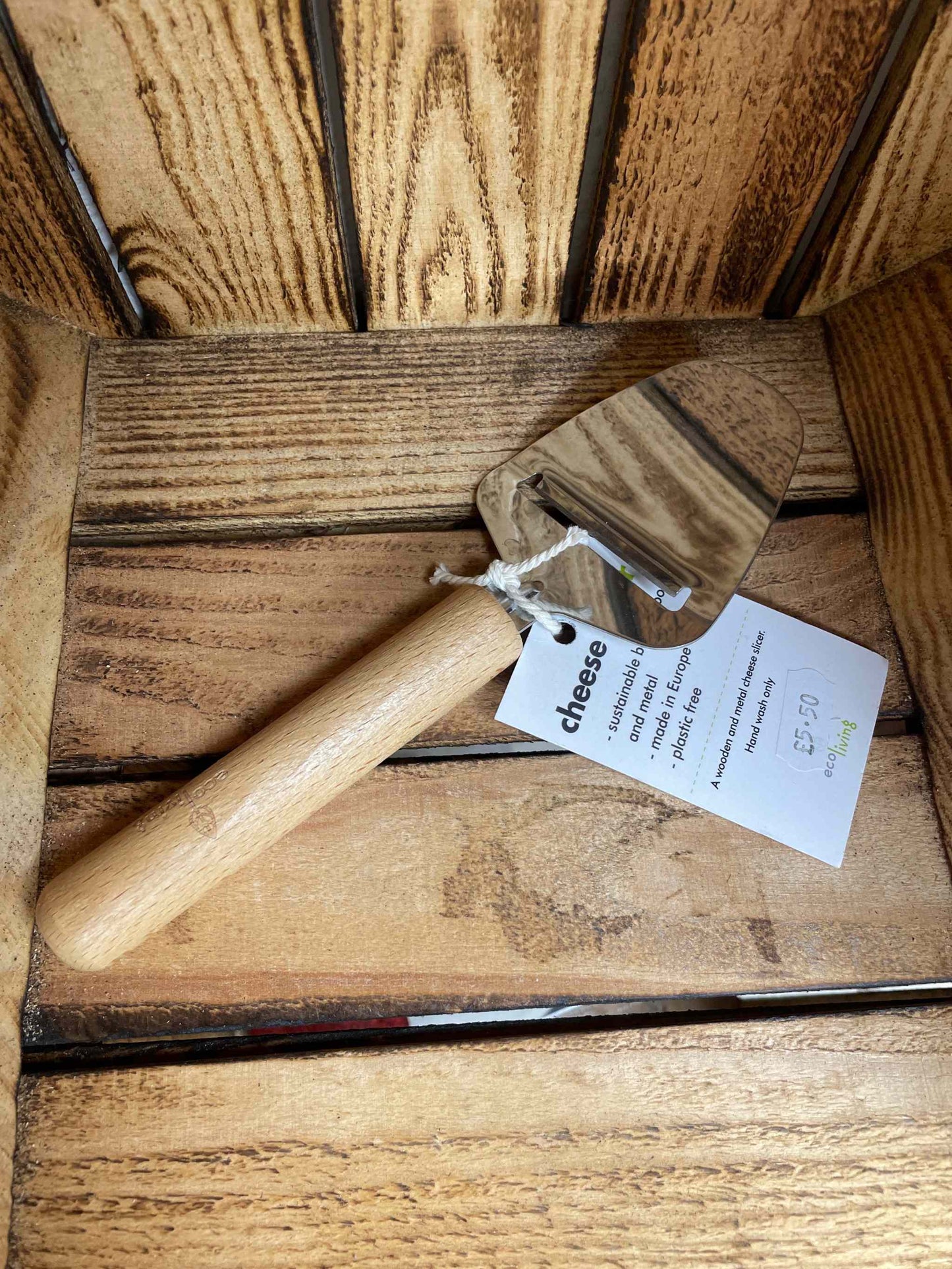 Wooden cheese slicer with FSC sustainable wood handle in a rustic wood finish.