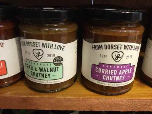 From Dorset With Love Chutney jars on a shelf, showcasing pear & walnut and curried apple flavors.