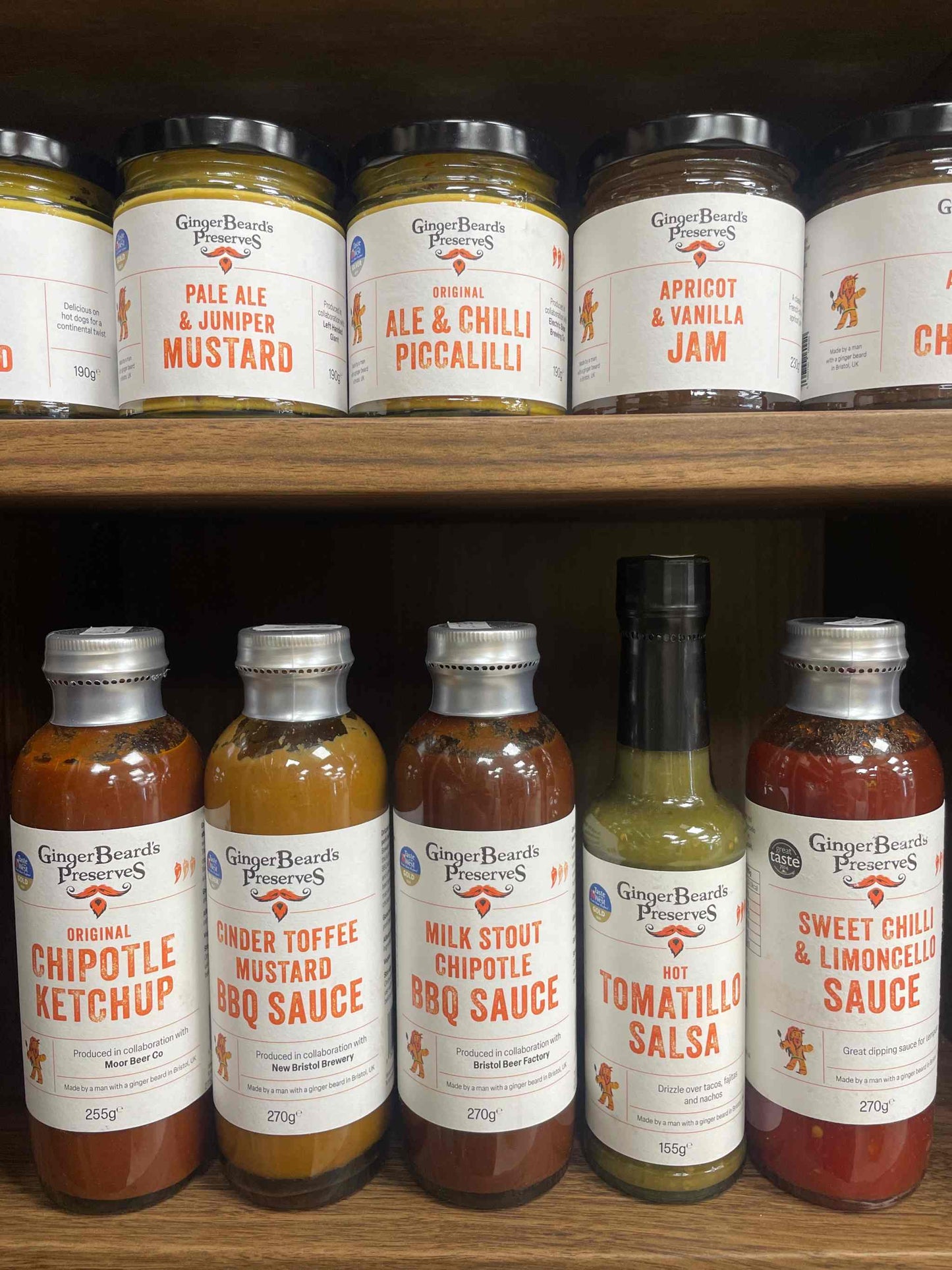 Shelf displaying Ginger Beard Preserves products, including Ale & Juniper Mustard.