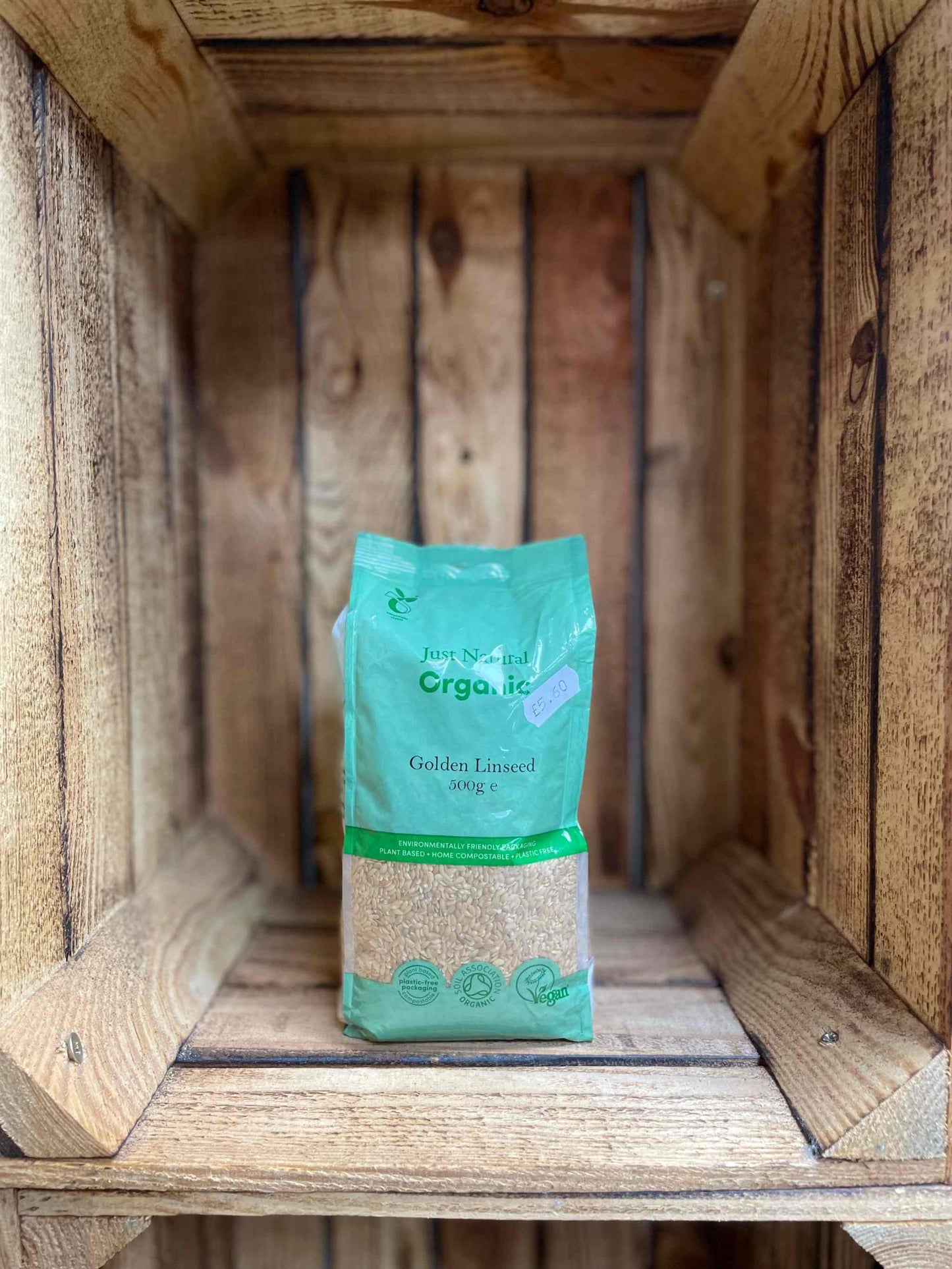 Organic Golden Linseed 500g package on wooden shelf, showcasing sustainably sourced and nutritious superfood.