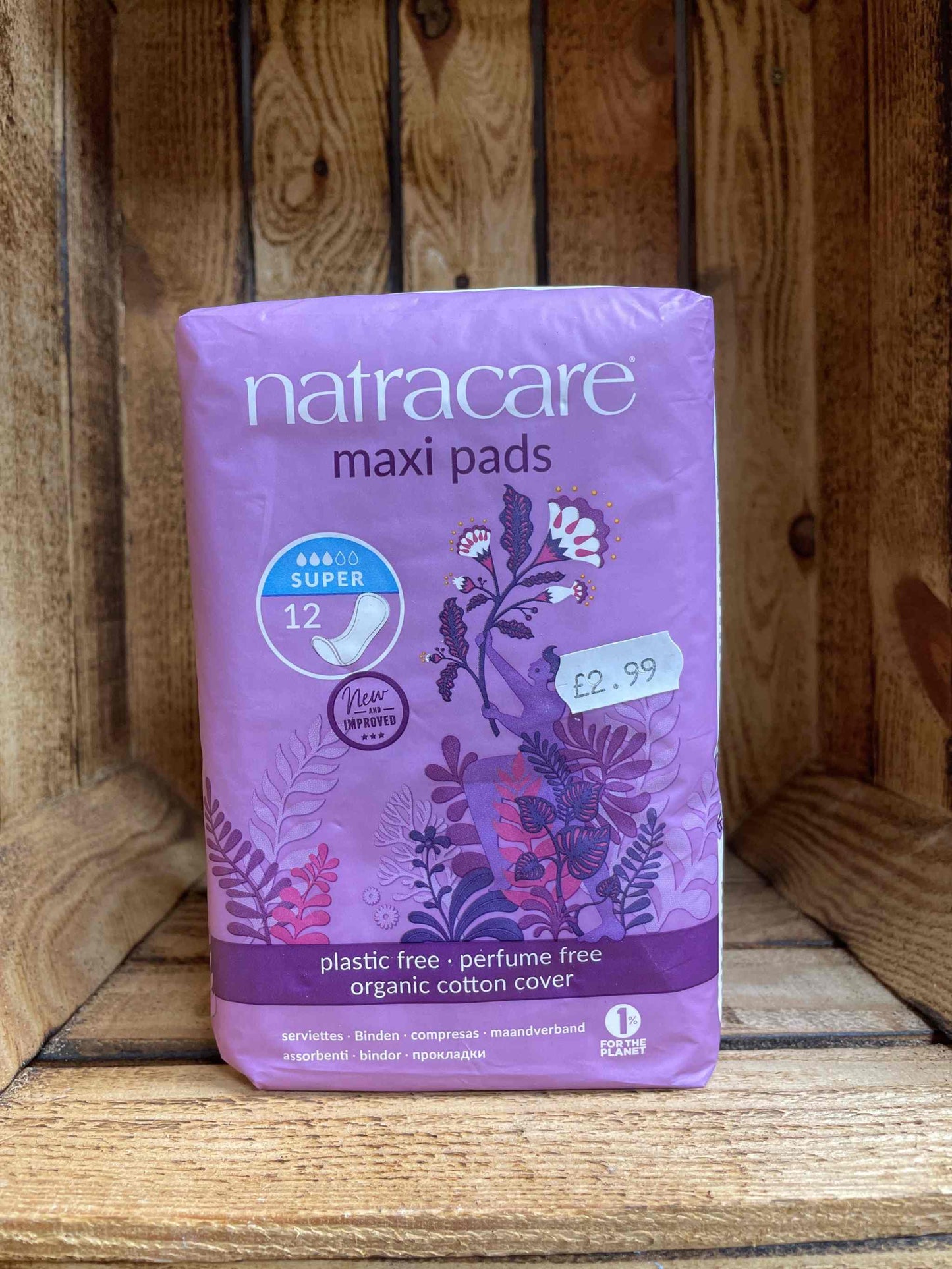 Natracare Maxi Pads packaging on wooden shelf.