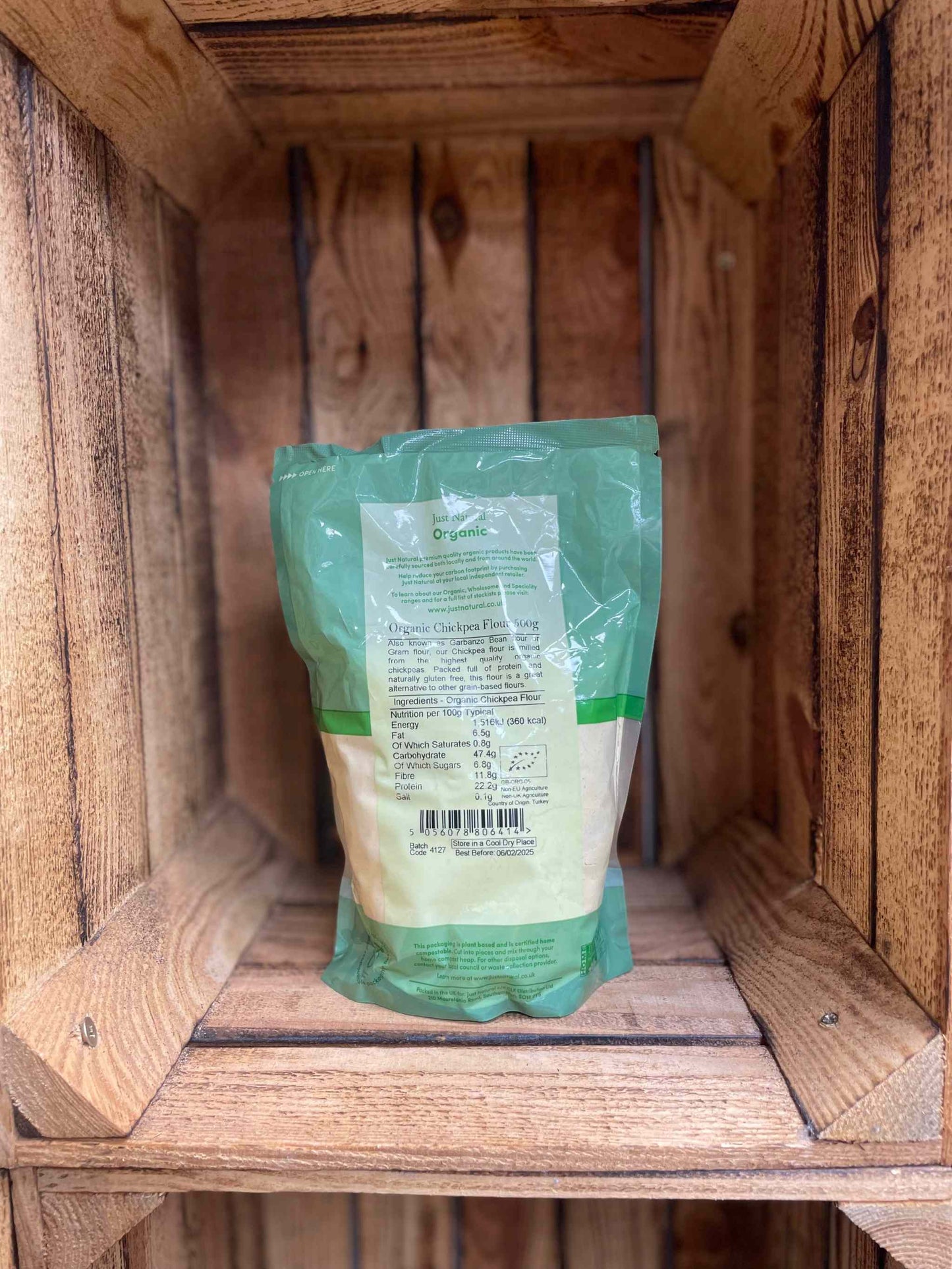 Organic Chickpea Flour 500g in eco-friendly packaging on wooden shelf.