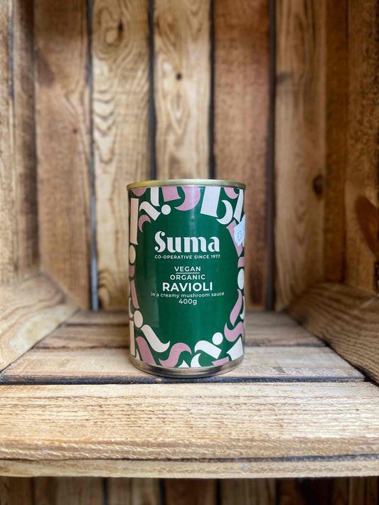 Suma Tins & Jars coconut milk can on wooden shelf, ideal for versatile cooking.