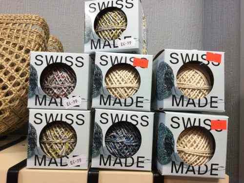 Recycled twine in dispenser boxes stacked on display.