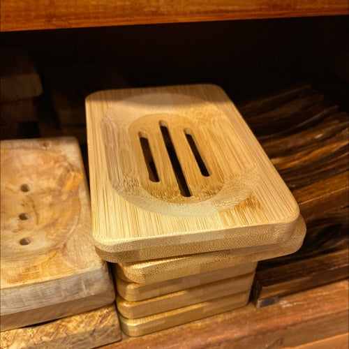 Eco-friendly bamboo soap dish with slotted design for drainage.